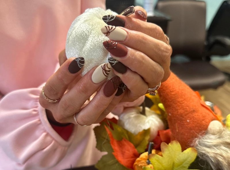 Seasonal nail art featuring holiday-themed decorative elements